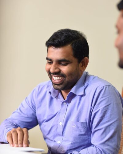 An male employee happily discussing